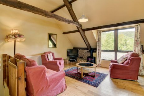 Lounge in Winsford Cottage with picture window looking out on The Aville Valley